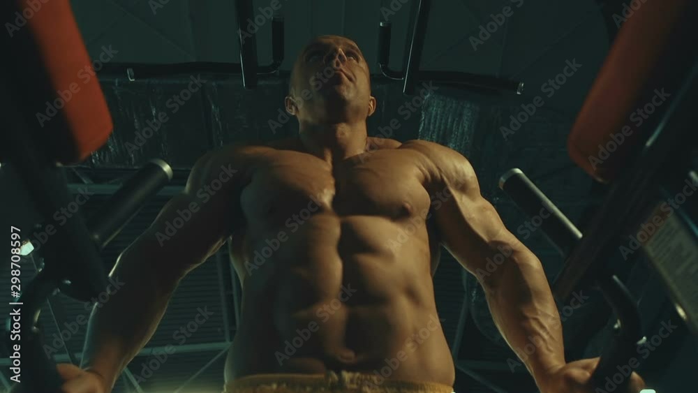 Handsome athletic men pumping up muscles push-ups on uneven bars workout fitness exercises and bodybuilding concept background - muscular bodybuilder fitness men doing bars exercises in gym torso Handsome athletic men pumping up muscles push-ups on uneven bars workout fitness exercises and bodybuilding concept background - muscular bodybuilder fitness men doing bars exercises in gym torso