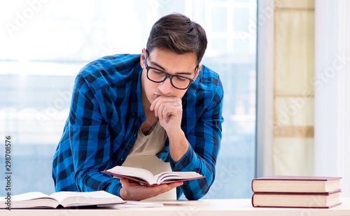 Student studying in the empty library with book preparing for ex photo