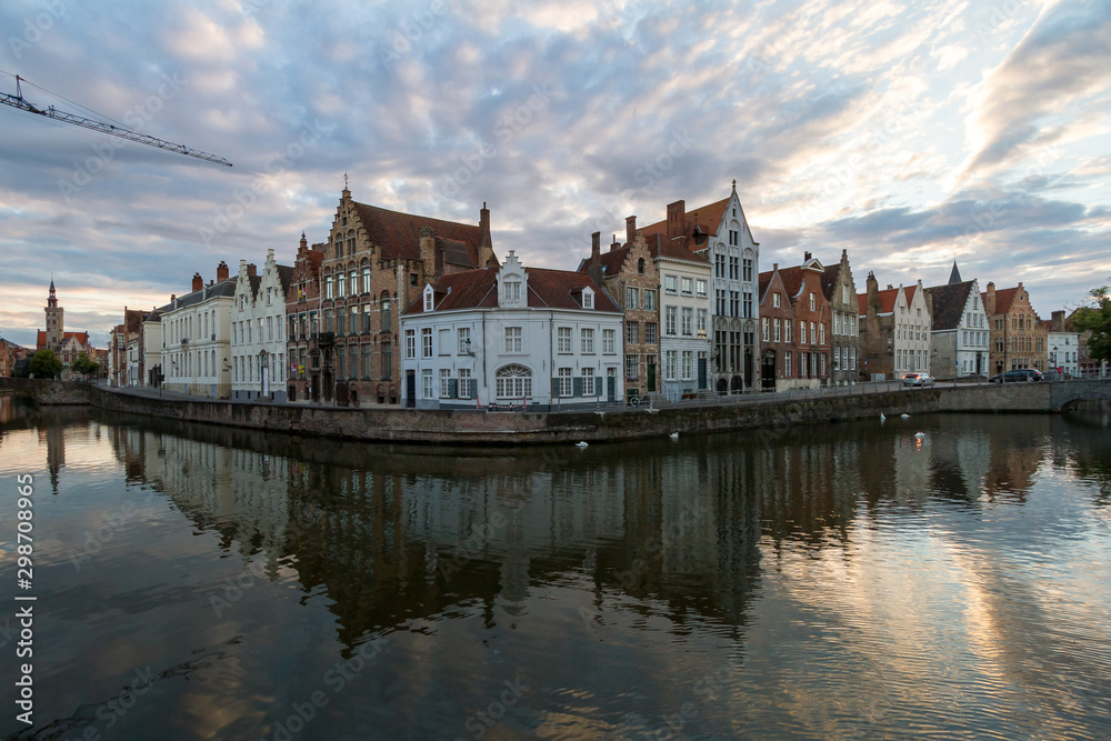 Bruges, Belgium. Panoramic view of houses along the canal embankment at sunset