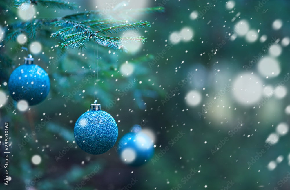 blue Christmas balls on Christmas tree branches background - obrazy, fototapety, plakaty 