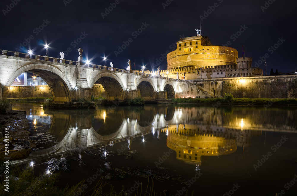 Long Exposure of Castel Sant'Angelo Roman symbol in the Rome city center captured in an autumn night with yellow lights.