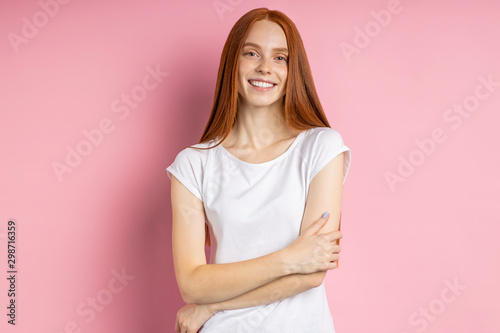 Portrait of young happy redhead woman in white t shirt