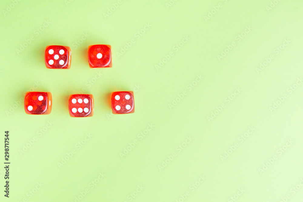 Red dice lying on a green background. from above. copy space Red dice lying on a green background. from above. copy space