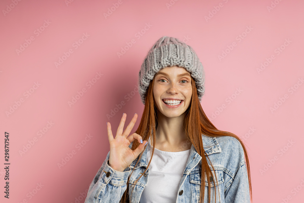 Portrait of excited young woman dressed denim jacket and knitted hat Portrait of excited young woman dressed denim jacket and knitted hat