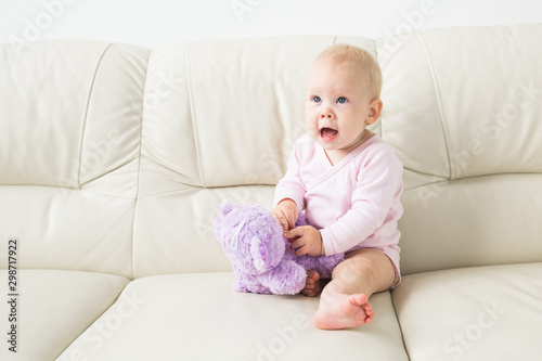 Children, infant and childhood concept - Beautiful cute soft baby sitting on sofa
