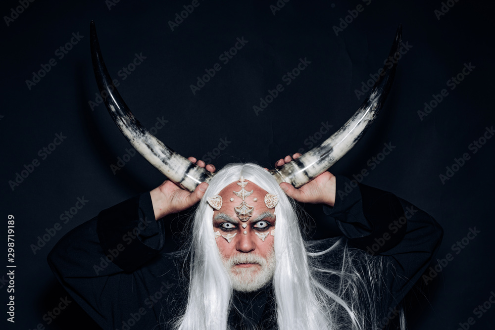 Demon with bloody horns on head. Devil horns. Devil horror concept