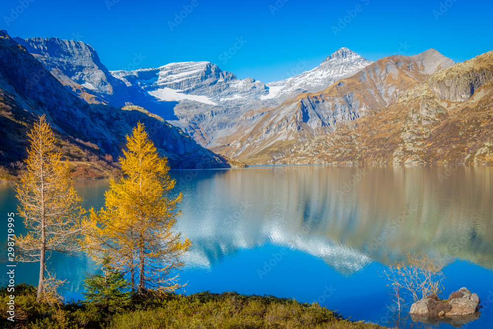 Mountain lake and blue sky in a beautiful autumnal landscape of Swiss Alps, Valais, Emosson, Switzerland, Europe.