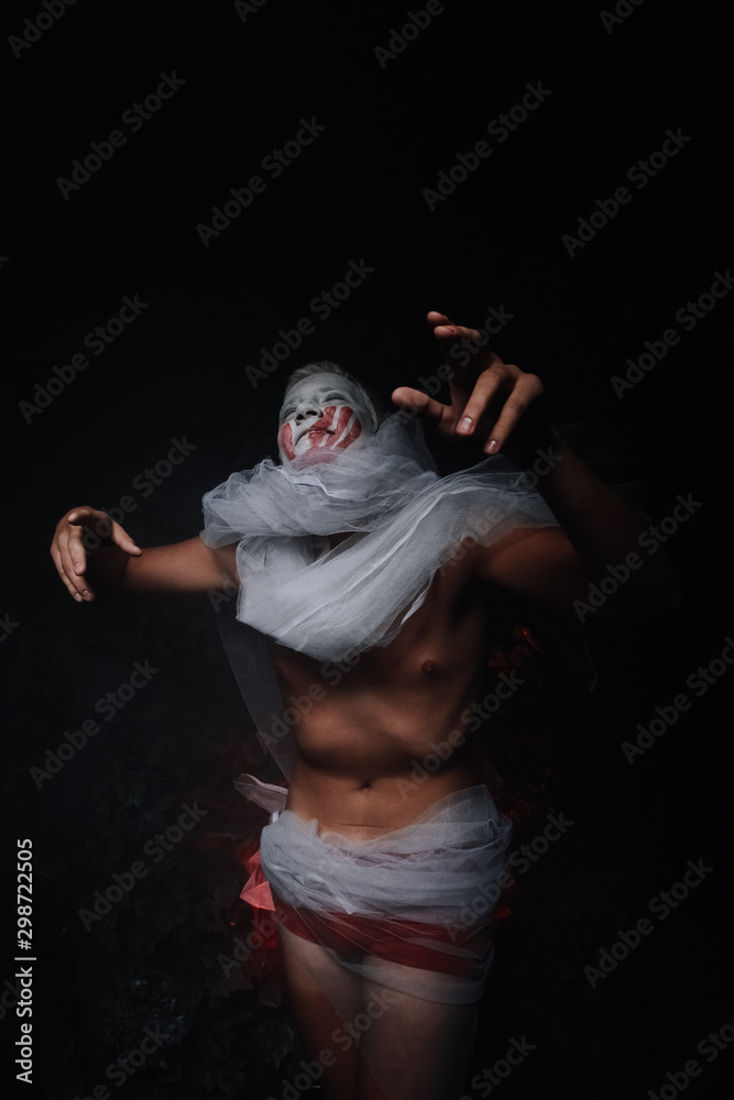 halloween make up. scary man ready for party. terrifying male with white painted face and dystrophic belly wears dead bride's veil in black Studio halloween make up. scary man ready for party. terrifying male with white painted face and dystrophic belly wears dead bride's veil in black Studio