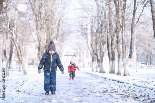 Kids walk in the park first snow © alexkich