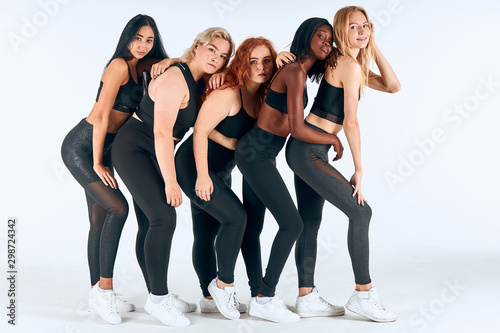 Young models of different sizes, nationalities, hairs. Model plus size, slim girls isolated over white background