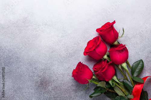 Fototapeta Naklejka Na Ścianę i Meble -  Red rose flowers bouquet on stone background Valentine's day greeting card Copy space