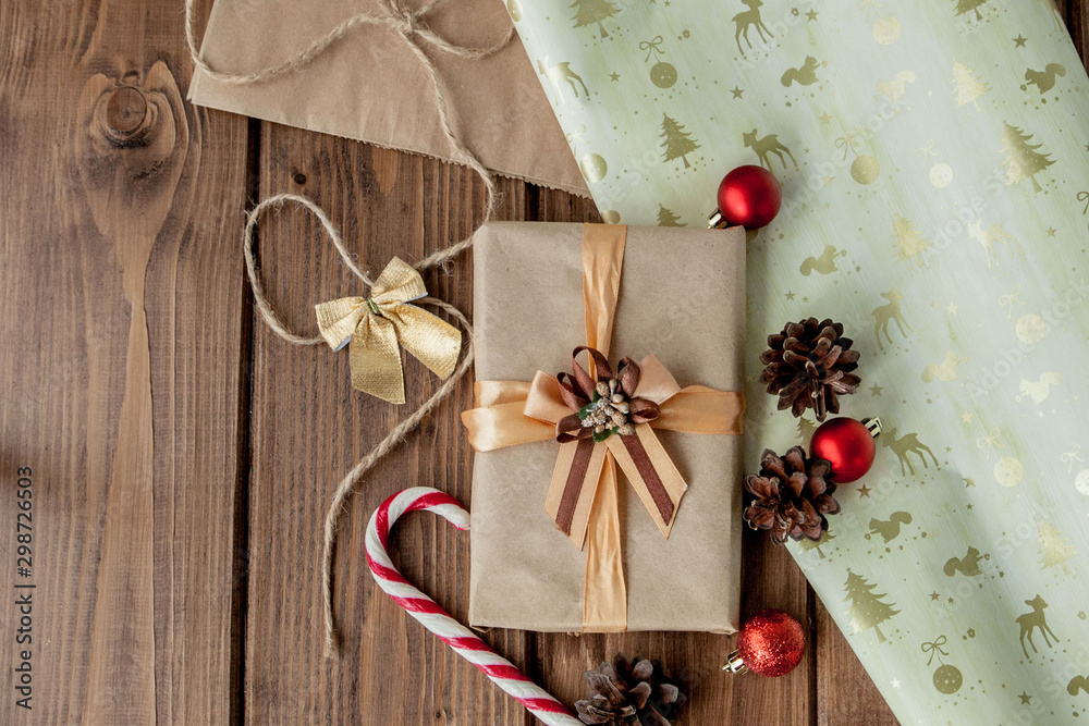 Christmas background with Christmas cones and toys, fir branches, giftboxes and decorations on a wooden table background Christmas background with Christmas cones and toys, fir branches, giftboxes and decorations on a wooden table background