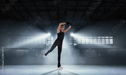 Figure skating girl in ice arena.