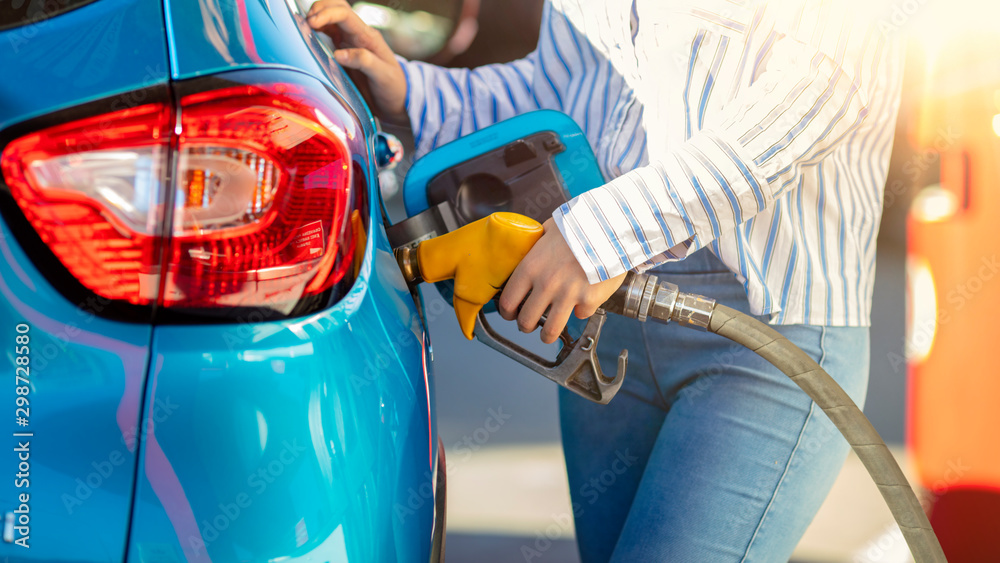 Pumping gas at gas pump. Woman refuel the car. Woman at the petrol