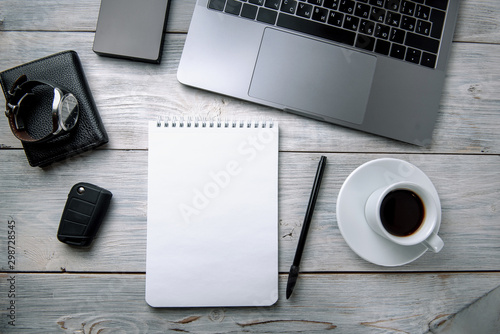 bright male banner / header with a stylish male workspace with laptop, smartphone, modern men's accessories on a wooden table, top view / flat lay