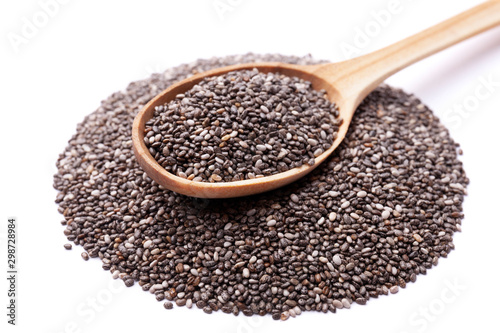 Chia seeds in wooden spoon isolated on white background. Superfood concept