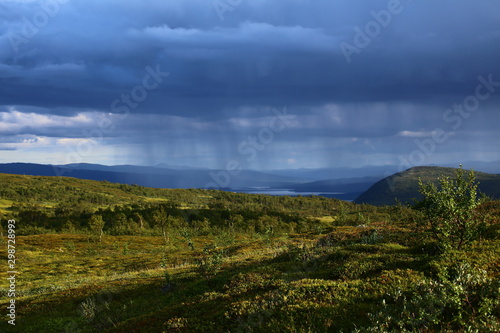 Sun and rain in Blasjofjalls nature reserve near the Wilderness Road in Sweden photo