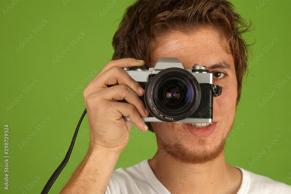 Young man taking photograph in studio Young man taking photograph in studio