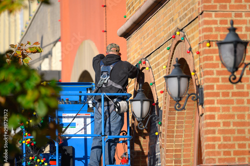 hanging Christmas lights for business