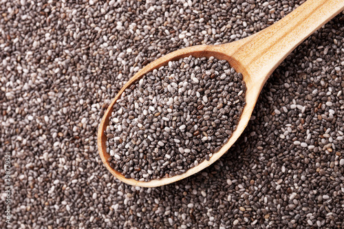 Chia seeds in wooden spoon closeup view. Super food concept