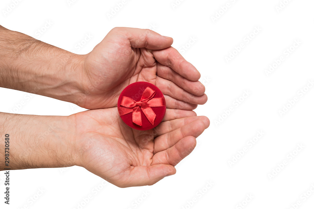 Red jewelry box in man hands. Present. White background. Top view Red jewelry box in man hands. Present. White background. Top view