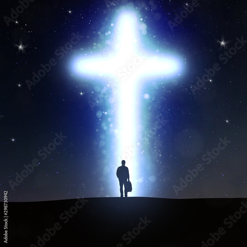 Man going to a bright shining cross at night