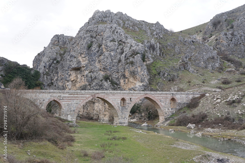 ancient bridge among rocky mountains