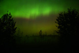 Northern lights over oncoming fog in the night