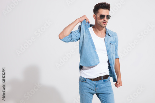 Motivated casual man adjusting his jacket