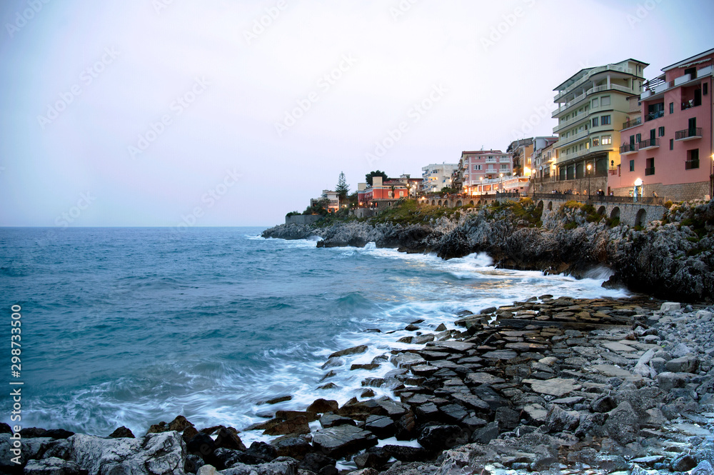 One of the inlets in the village of Marina di Camerota, Salerno, Italy. Promontory with promenade at twilight.