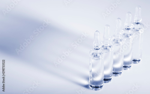 Glass medicine ampoules on a white background