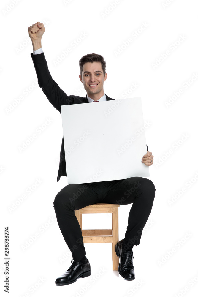 Succesful businessman celebrating and holding a blank billboard Succesful businessman celebrating and holding a blank billboard