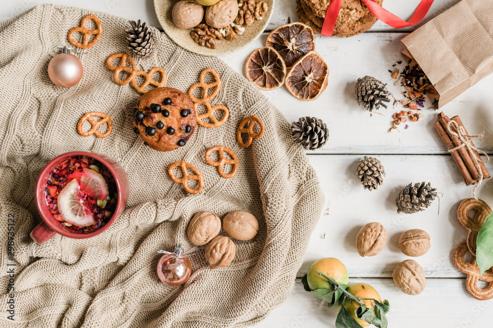 Knitted sweater, homemade cookies and hot drink, walnuts, pinecones and spices Knitted sweater, homemade cookies and hot drink, walnuts, pinecones and spices