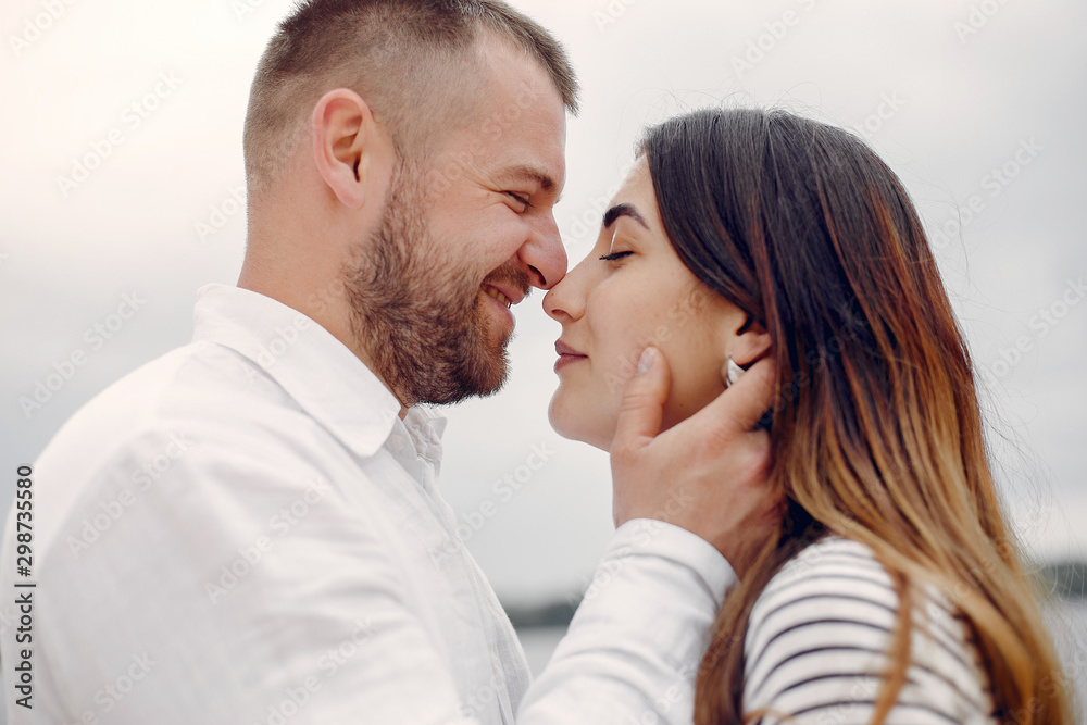 Couple in a park. Woman with long curly hair. Man with his wife Couple in a park. Woman with long curly hair. Man with his wife