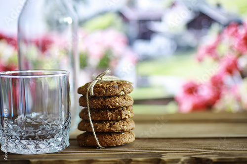 Fresh oatmeal cookies with milk on a texture wood background. Christmas gingerbread cookie and a glass of milk.