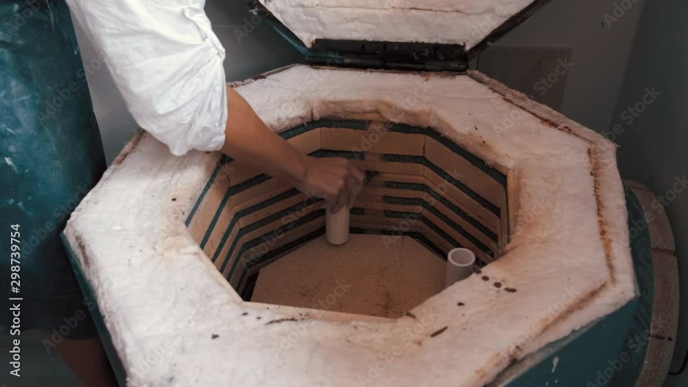potter preparing the pottery kiln for the baking process for her dish
