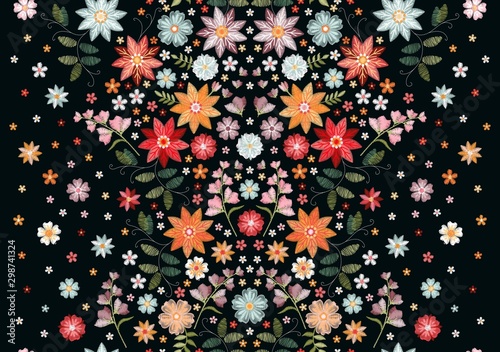 Symmetric seamless embroidery pattern with beautiful flowers and leaves on black background.