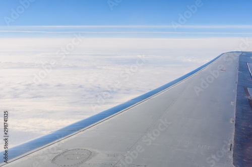 View on white clouds and wing from the airplane window