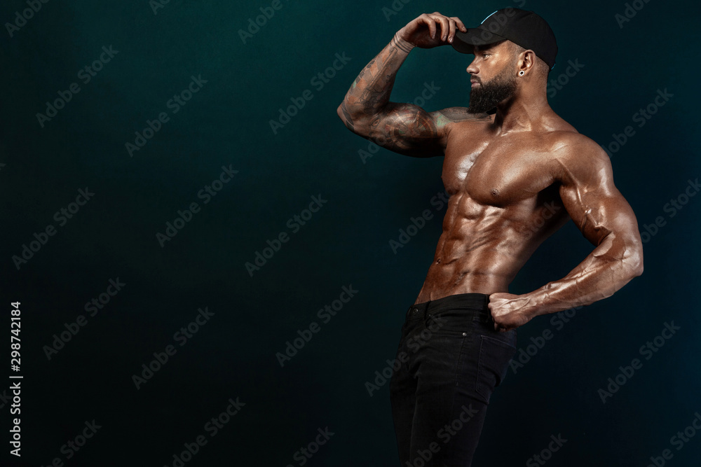 Fototapeta premium Strong and fit man bodybuilder. Sporty muscular guy athlete. Sport and fitness concept. Men's fashion.