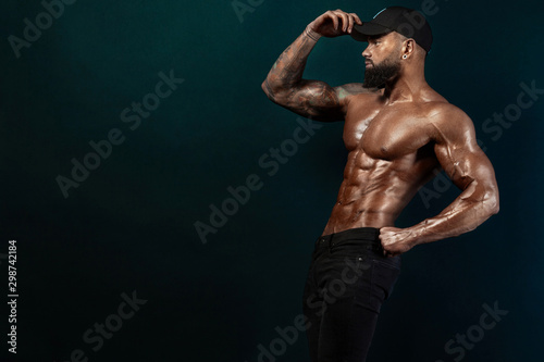 Strong and fit man bodybuilder. Sporty muscular guy athlete. Sport and fitness concept. Men's fashion. © Mike Orlov