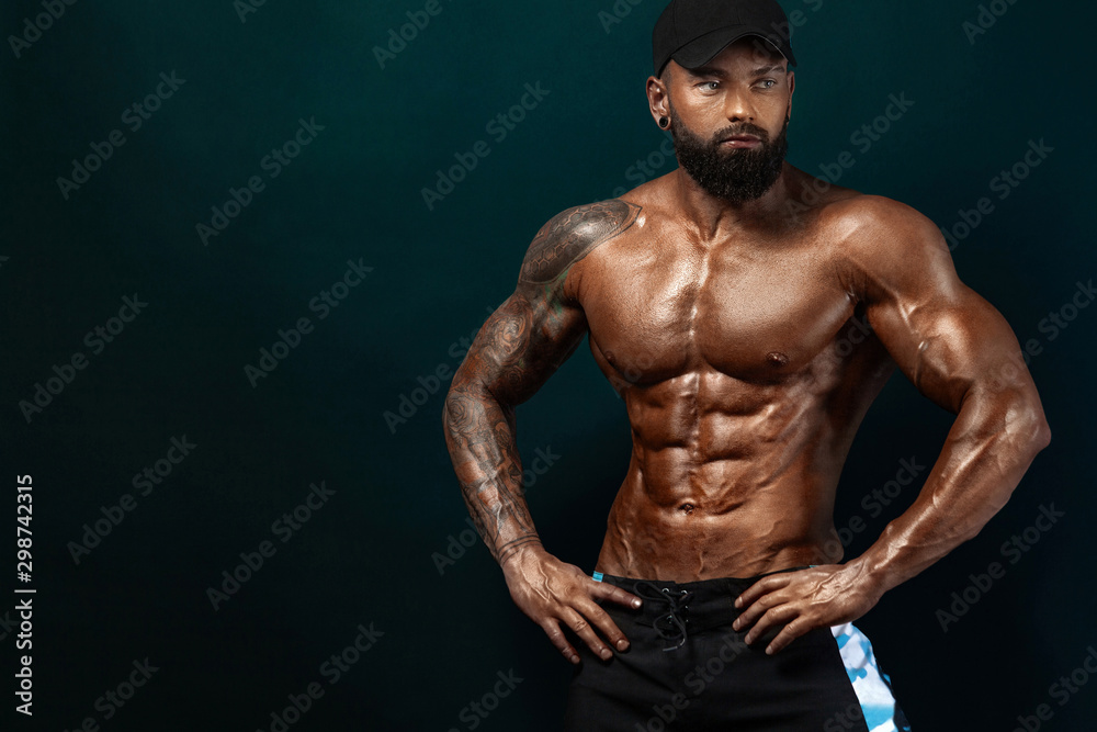 Fotka „Strong and fit man bodybuilder. Sporty muscular guy athlete. Sport  and fitness concept. Men's fashion.“ ze služby Stock | Adobe Stock