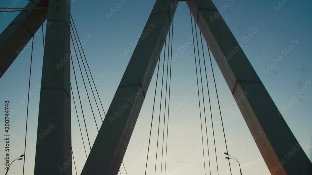 auto drives along cable-stayed Millennium bridge at sunset auto drives along cable-stayed Millennium bridge at sunset