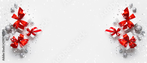 Christmas and New Year holiday background. Xmas greeting card. Christmas red ribbon gifts on white background top view. Flat lay