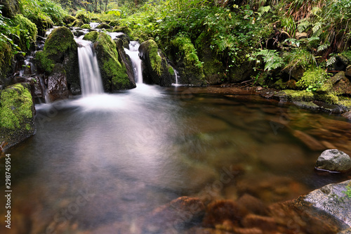 Small waterfall on the river with rocks.