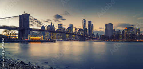 Brooklyn bridge East river and Manhattan after sunset, New York City © sborisov