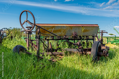 Vintage farming one way disc surrounded by tall grass  photo