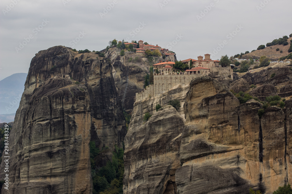 Christian highland monastery pilgrimage religion destination for believer people in Greece gorgeous rocky mountain wilderness scenic landscape environment in cloudy moody weather time 