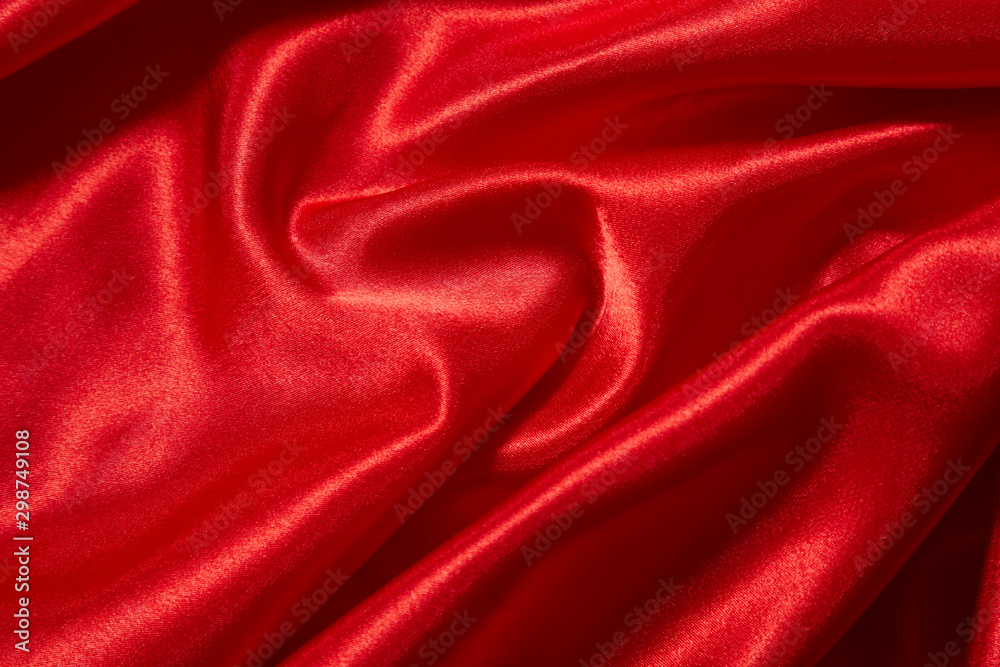 Fototapeta premium Luxury red satin smooth fabric background for celebration, ceremony, event invitation card or advertising poster