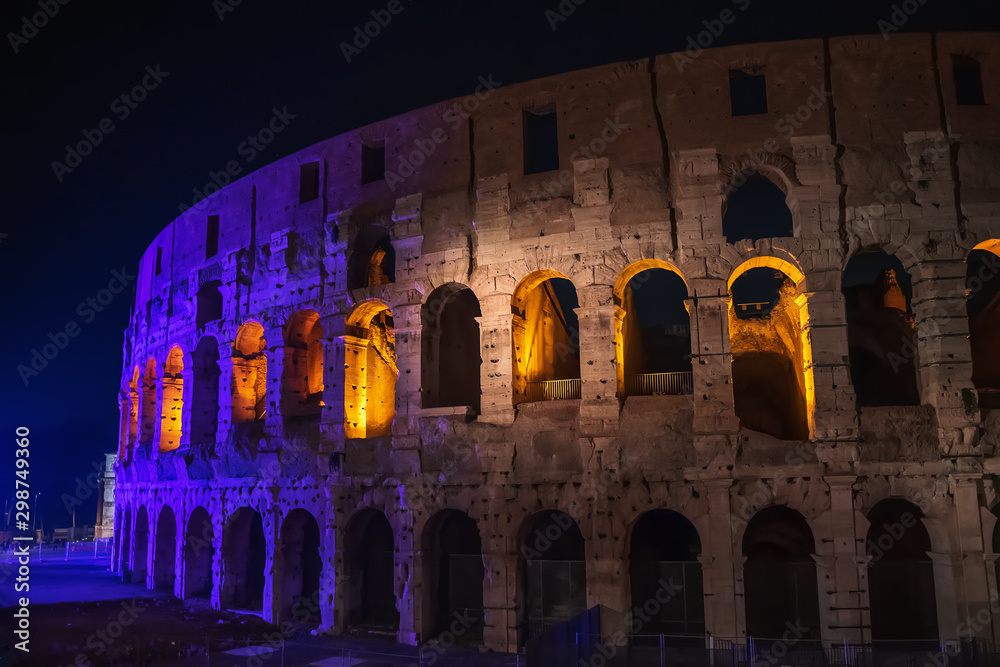 The Colosseum or Coliseum at night, beautiful historic building, symbol of Rome, Italy.