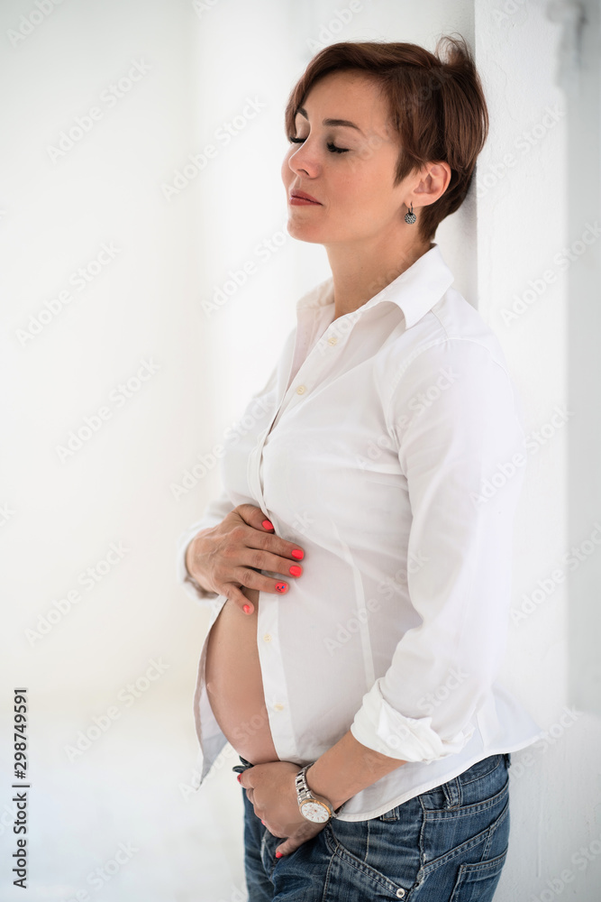 Pregnancy Concept. Stylish Pregnant Mid-Aged Woman in Modern PhotoStudio. Pregnancy Concept. Stylish Pregnant Mid-Aged Woman in Modern PhotoStudio.